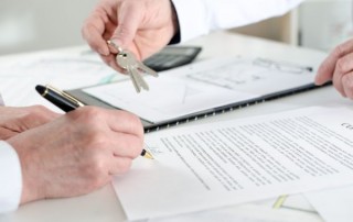 Client signing a real estate contract in real estate agency