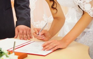 Bride signing marriage license or wedding contract